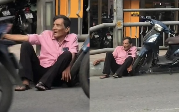 Diễn viên Thương Tín ngồi bệt bên lề đường